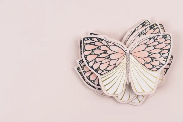 Butterfly-shaped cards on a light pink background
