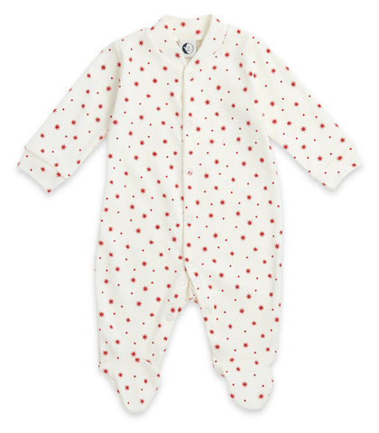 White baby onesie with red star and dot pattern on a white background