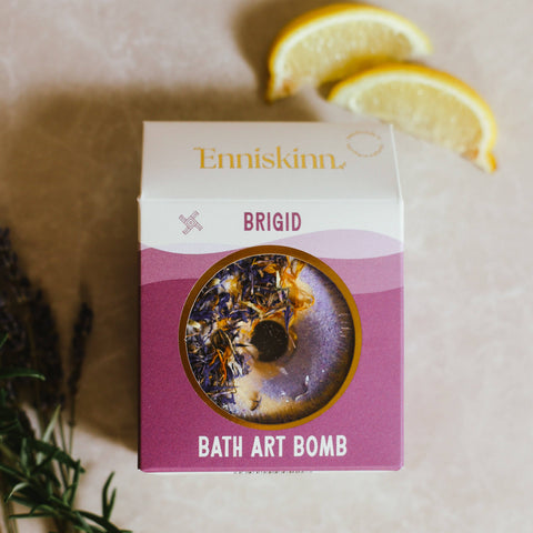 Enniskinn Brigid Bath Art Bomb packaging with lavender and lemon on a neutral background