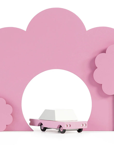 Pink toy car among a pink display 