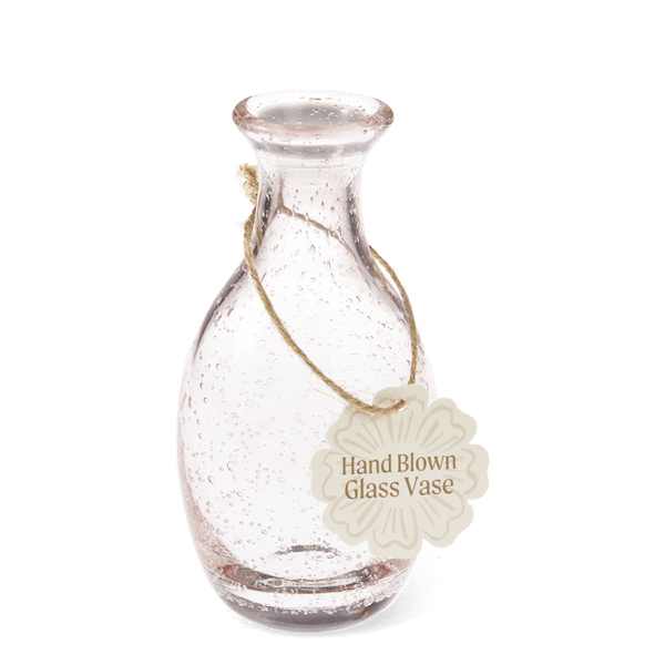 Hand blown glass vase with a tag on a white background