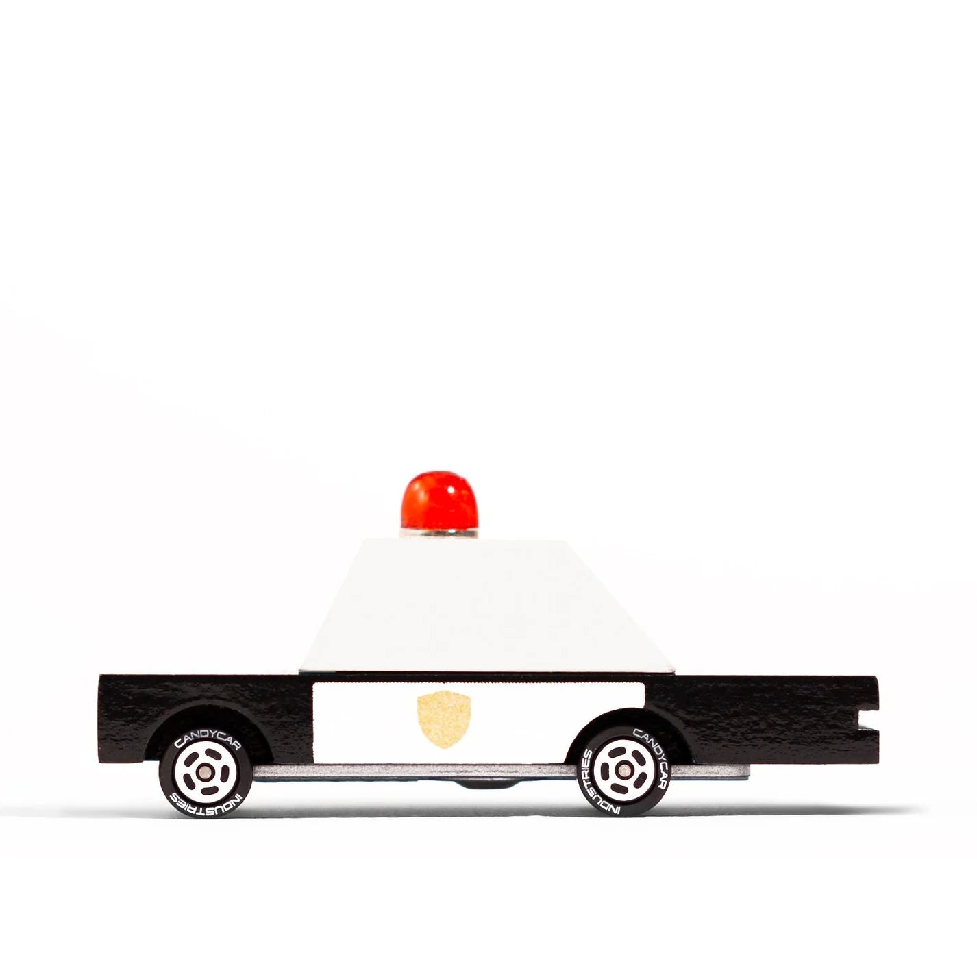 Toy police car with a red light on a white background