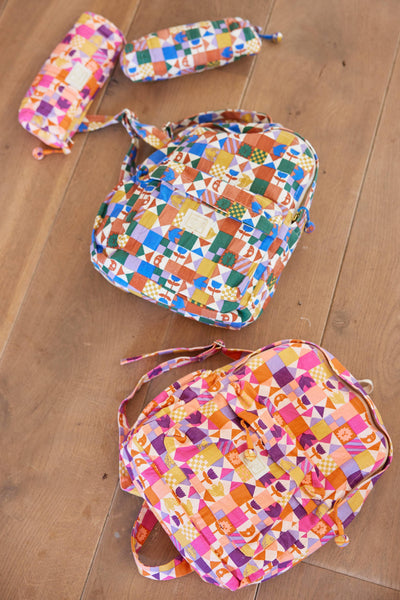 Colourful patterned bags on a wooden floor