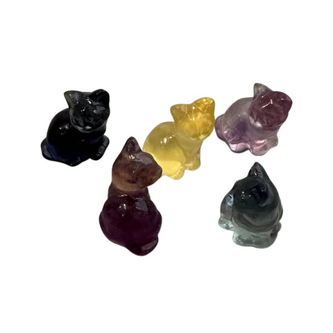 Five crystal cat figurines in different colours on a white background