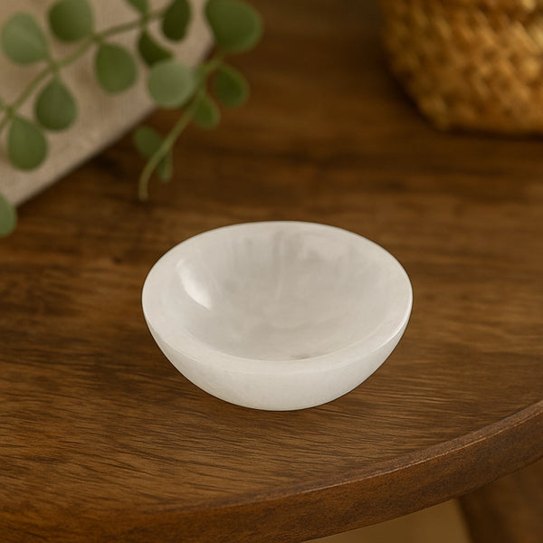 White crystal bowl on a wooden surface with a blurred background