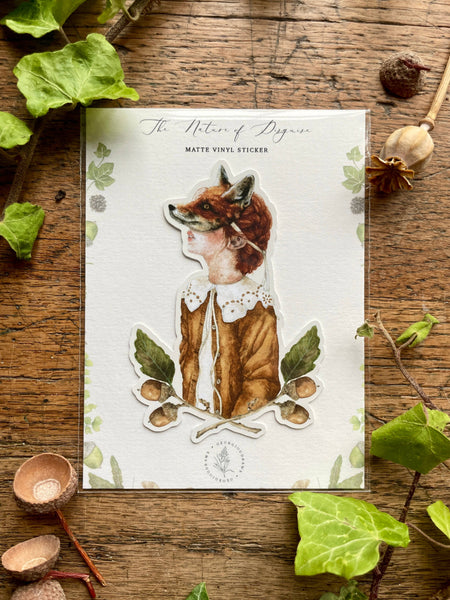 Sticker of a girl wearing a fox mask in a vintage outfit on a wooden surface with leaves and nuts.