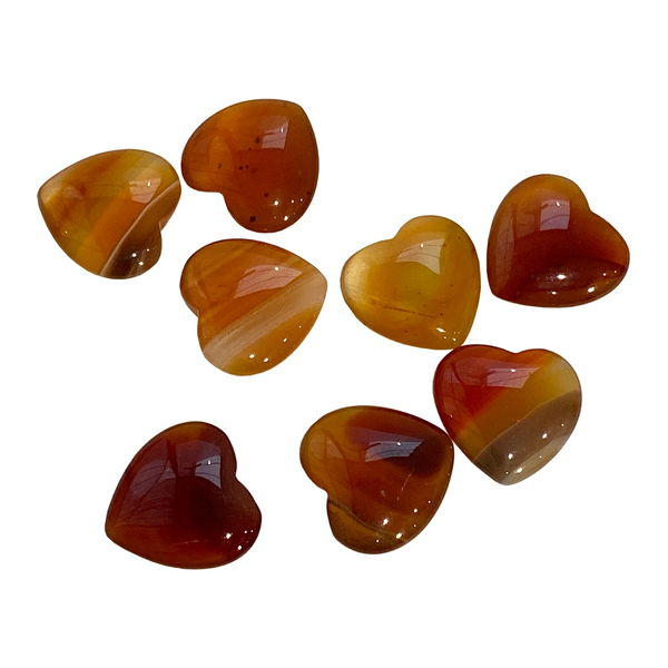 Heart-shaped carnelian gemstones on a white background
