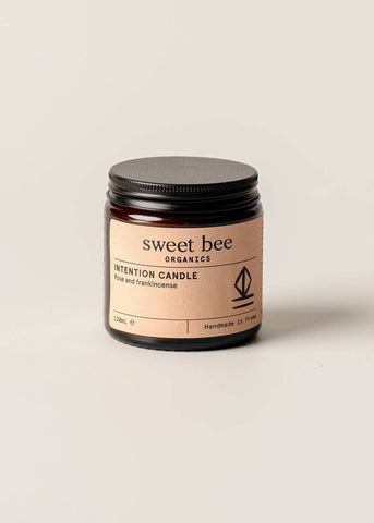 Sweet Bee Organics candle on a beige background