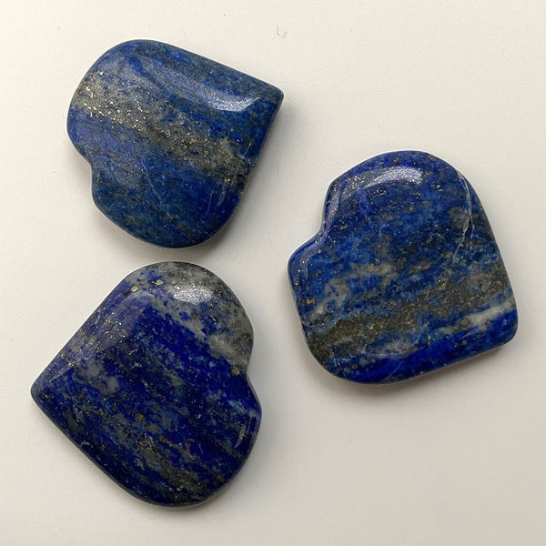 Three lapis lazuli stones on a white background