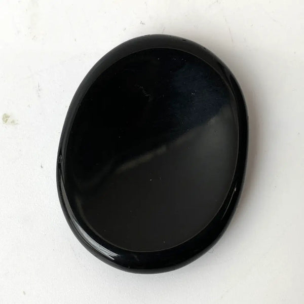 Black obsidian stone on a white background