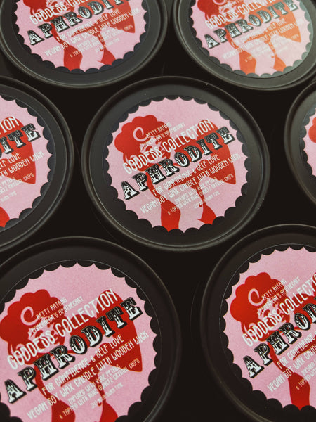 Multiple candles with 'Goddess Collection - Aphrodite' label on a black background