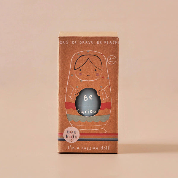Box packaging of a Russian doll toy with 'bee kids' branding on a beige background