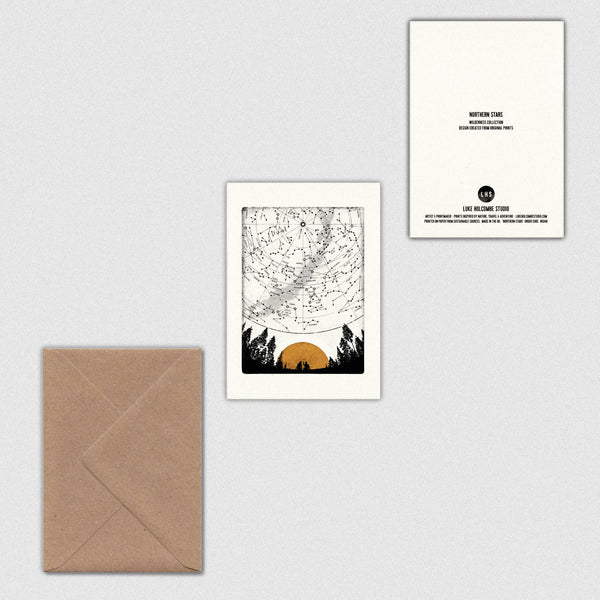 Front and back of a greeting card featuring a sunset over trees with a matching envelope on a light grey background