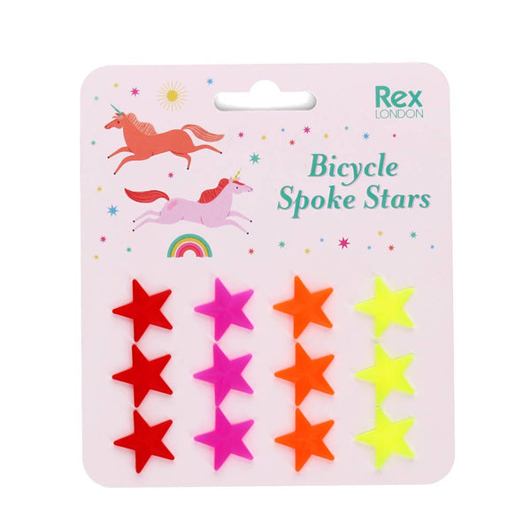Packaged bicycle spoke stars with colourful stars on a pink background, featuring the brand 'Rex London'.