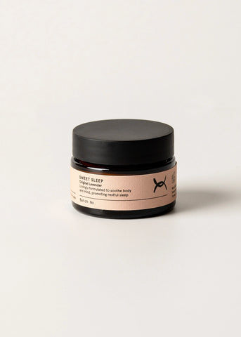 Jar of 'Sweet Sleep' cream with a black lid on a light background