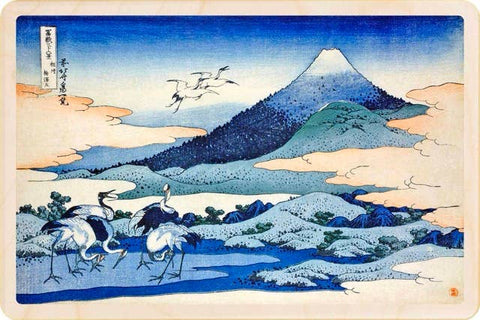 Traditional Japanese woodblock print of cranes by a mountain landscape
