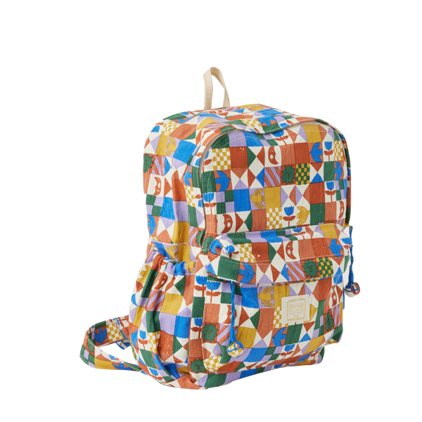 Multicoloured geometric patterned backpack on a white background