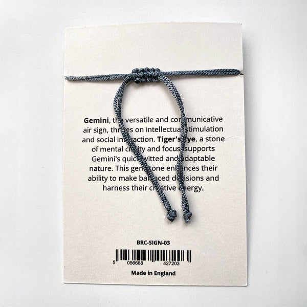 Bracelet on a card with text and branding details on a white background