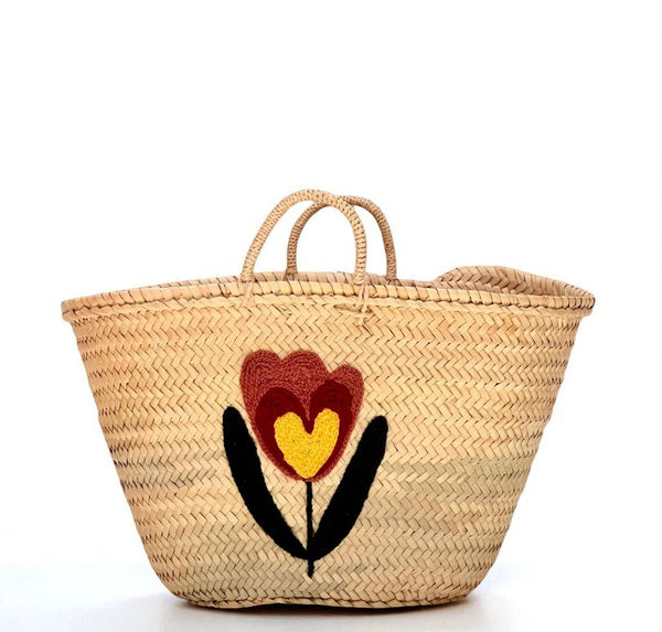 Woven basket with floral design on a white background