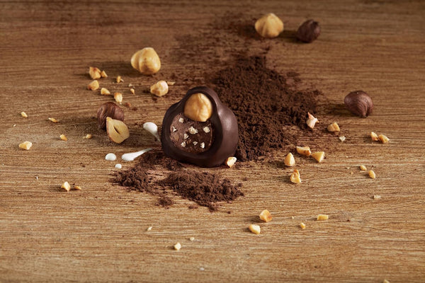 Chocolate truffles with nuts on a wooden surface