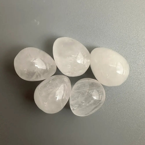 Five clear crystals on a grey background