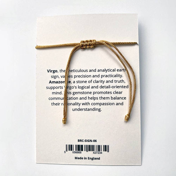 Gold cord bracelet on a card with text and branding details