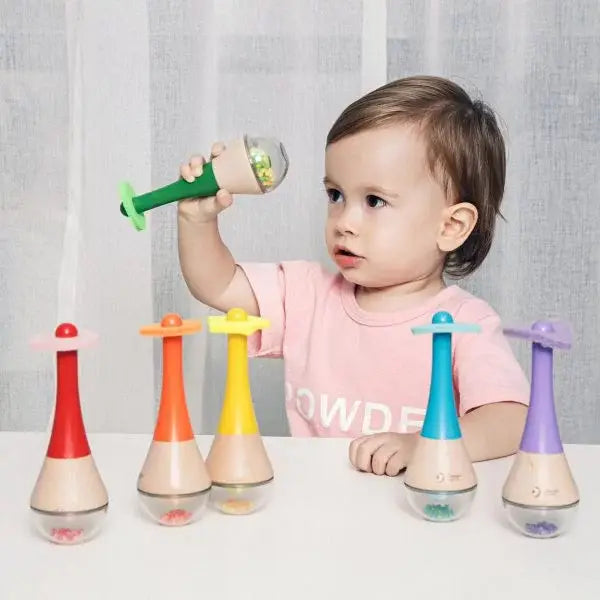 Child playing with colourful educational toys on a table