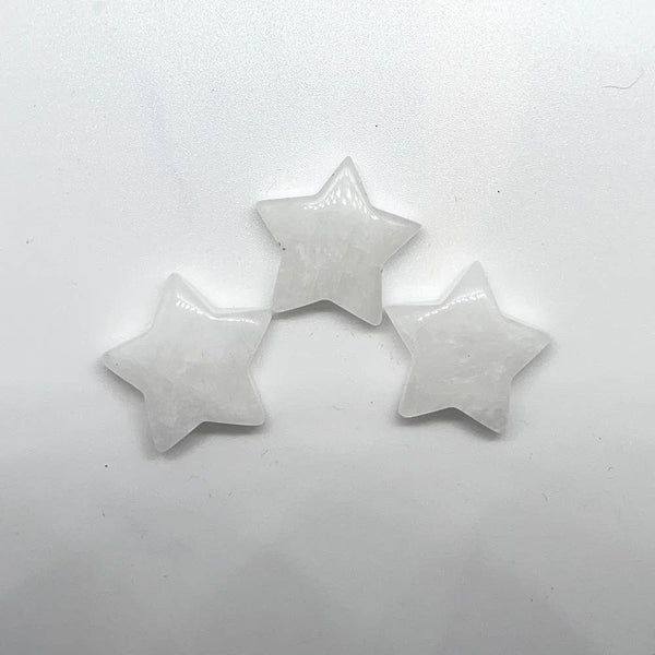 Three star-shaped gemstones on a white background