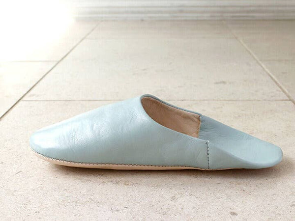 Light blue slipper on a light tiled floor