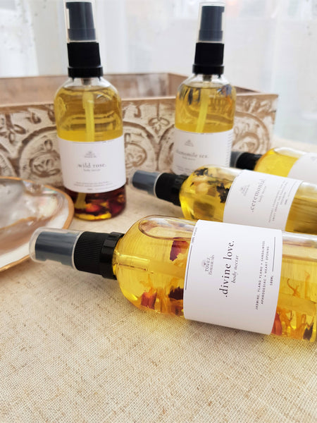 Bottles of 'divine love' product on a textured surface with a blurred background
