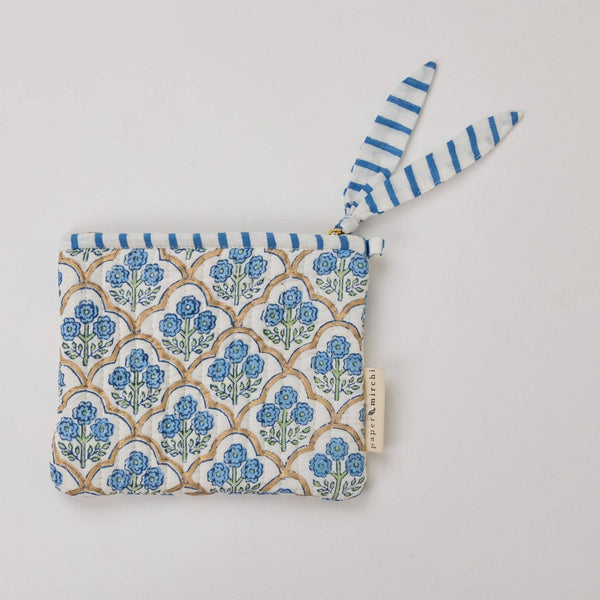 Fabric pouch with blue floral pattern and striped trim on a light background