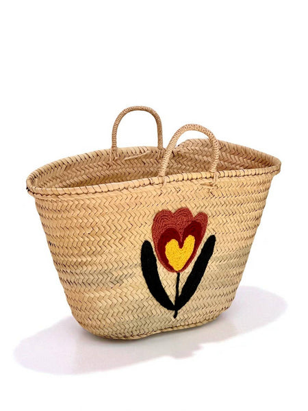 Woven basket with floral design on a white background