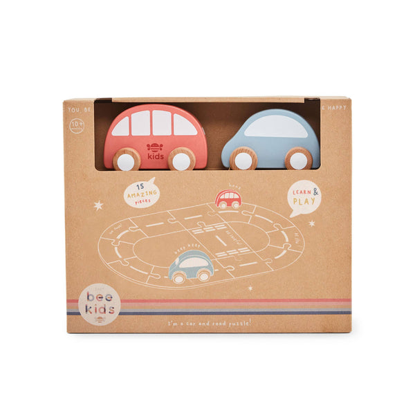 Boxed toy car set with two cars and a track diagram on a white background