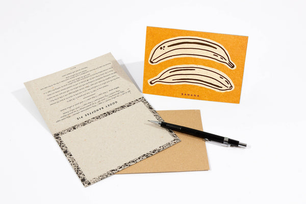 Recipe notecard with banana illustration and pen on a white background