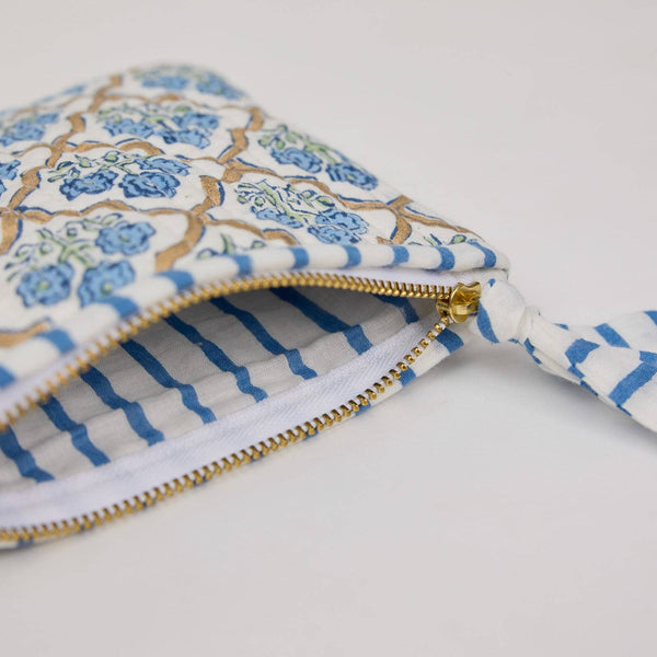 Patterned pouch with a gold zipper on a white background
