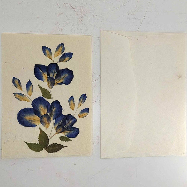 Floral illustration on a beige card with a plain white envelope.