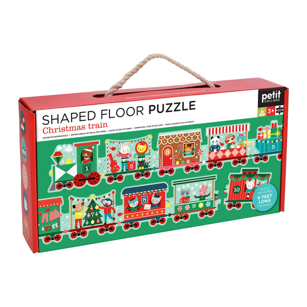 Shaped floor puzzle packaging for a Christmas train theme on a white background