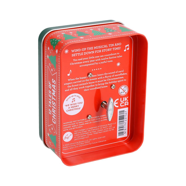 Red wind-up musical tin with Christmas-themed design on a white background