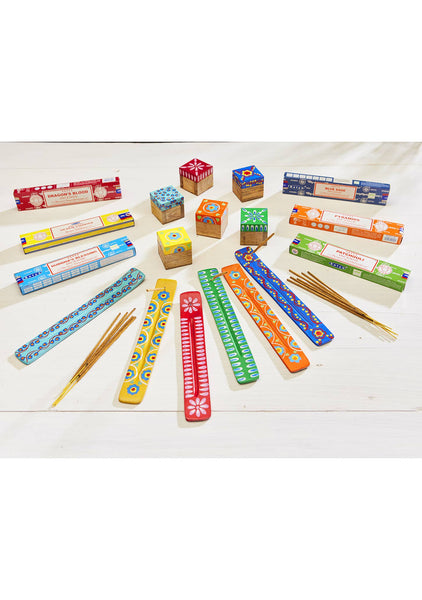 Assorted incense sticks and packaging on a white surface