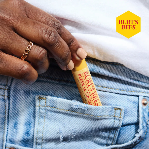 Person holding a Burt's Bees lip balm with a visible Burt's Bees logo.