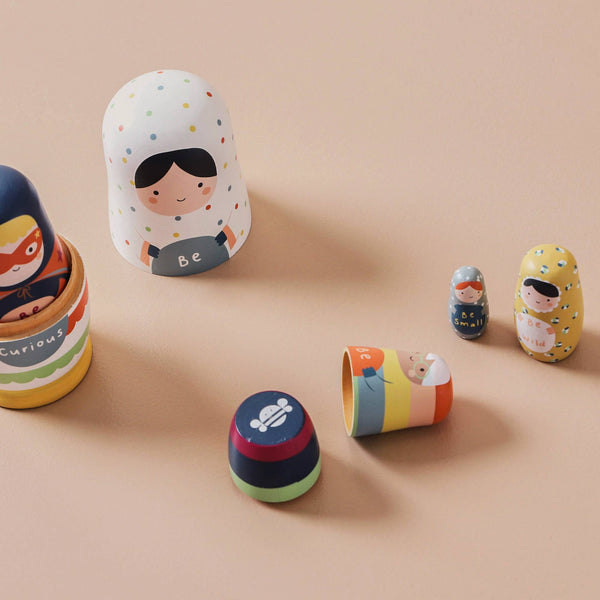 Colourful nesting dolls on a beige background