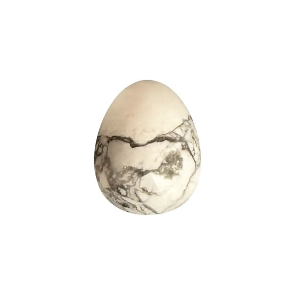 Marble-patterned crystal egg on a white background