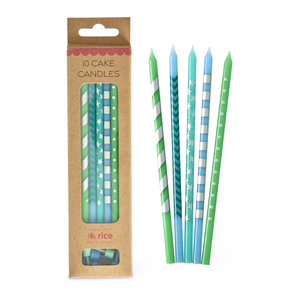 Pack of cake candles with green and blue designs next to their packaging