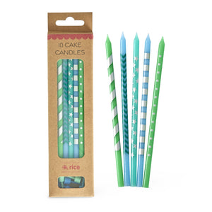 Pack of cake candles with green and blue designs next to their packaging