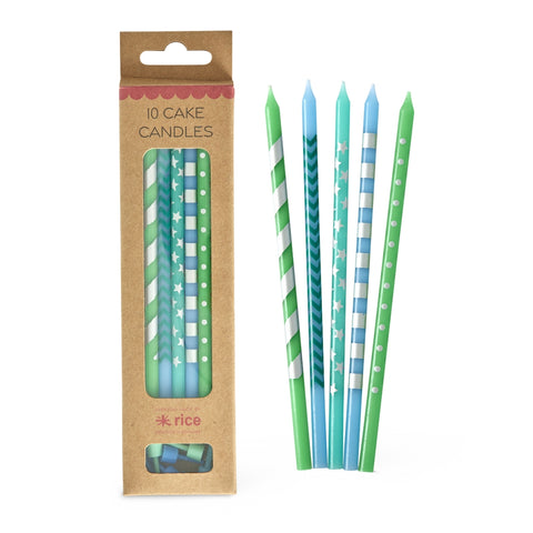 Pack of cake candles with green and blue designs next to their packaging