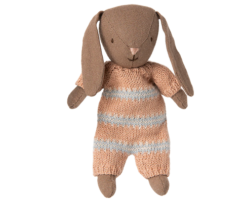 Brown stuffed bunny toy in pink and white striped playsuit against a white background
