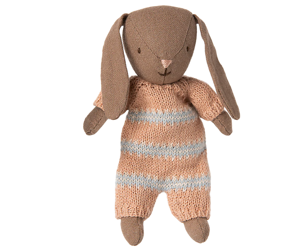 Knitted toy rabbit with a striped outfit on a white background