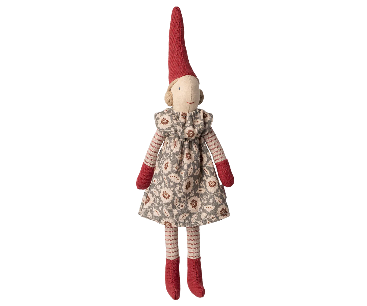 Stuffed pixy toy with a red hat and floral dress on a white background