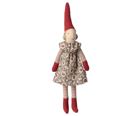 Stuffed pixy toy with a red hat and floral dress on a white background
