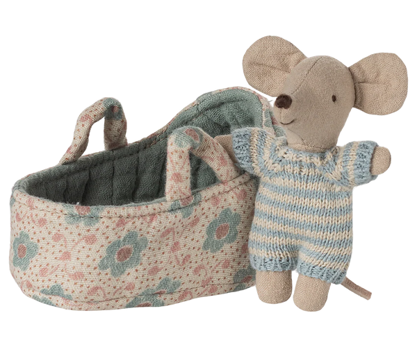 Toy mouse next to a floral-patterned carry cot on a white background